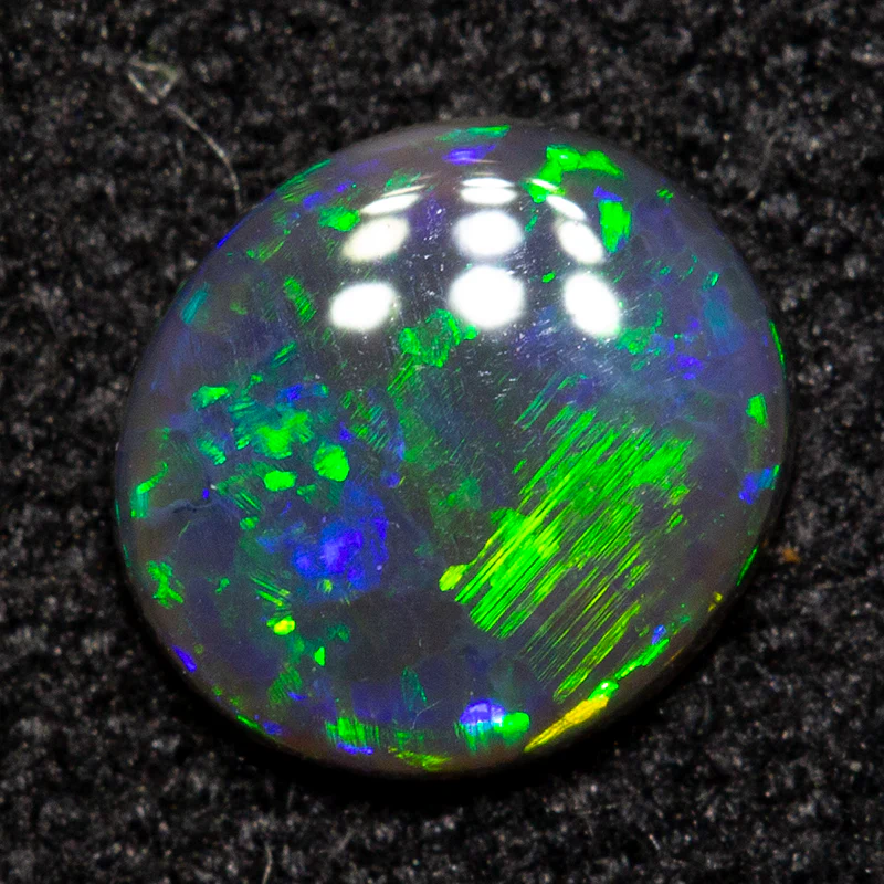 0.32 ct black opal 5.6x5.1x1.5mm