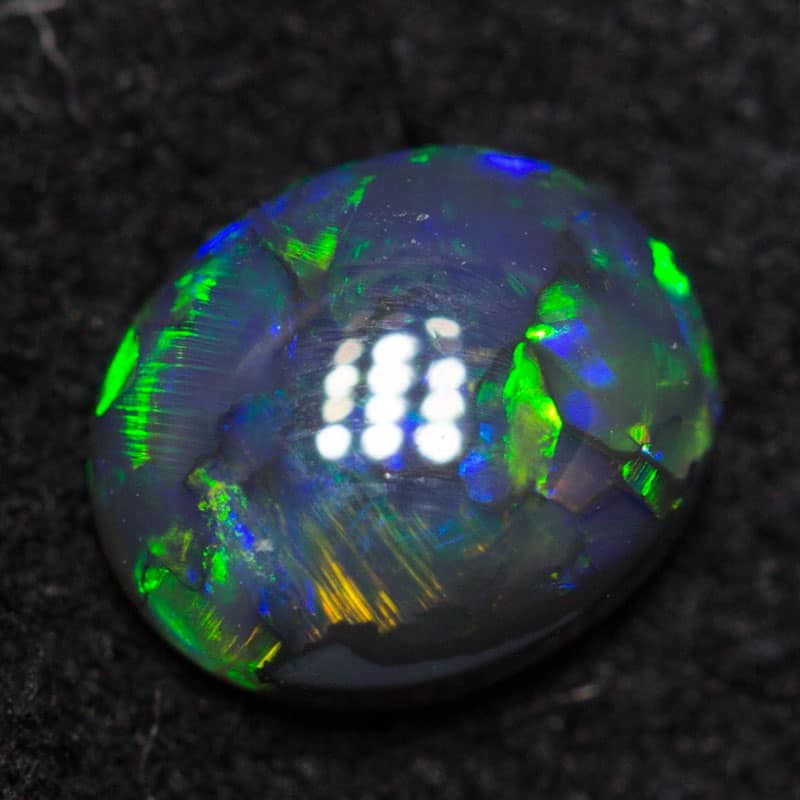 0.41 ct black opal 5.8x4.8x2.3mm