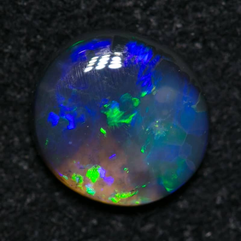 0.48 ct black opal 6mm round x2mm