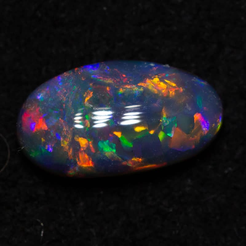 0.56 ct black opal gem 7.8x4.3x2.6mm