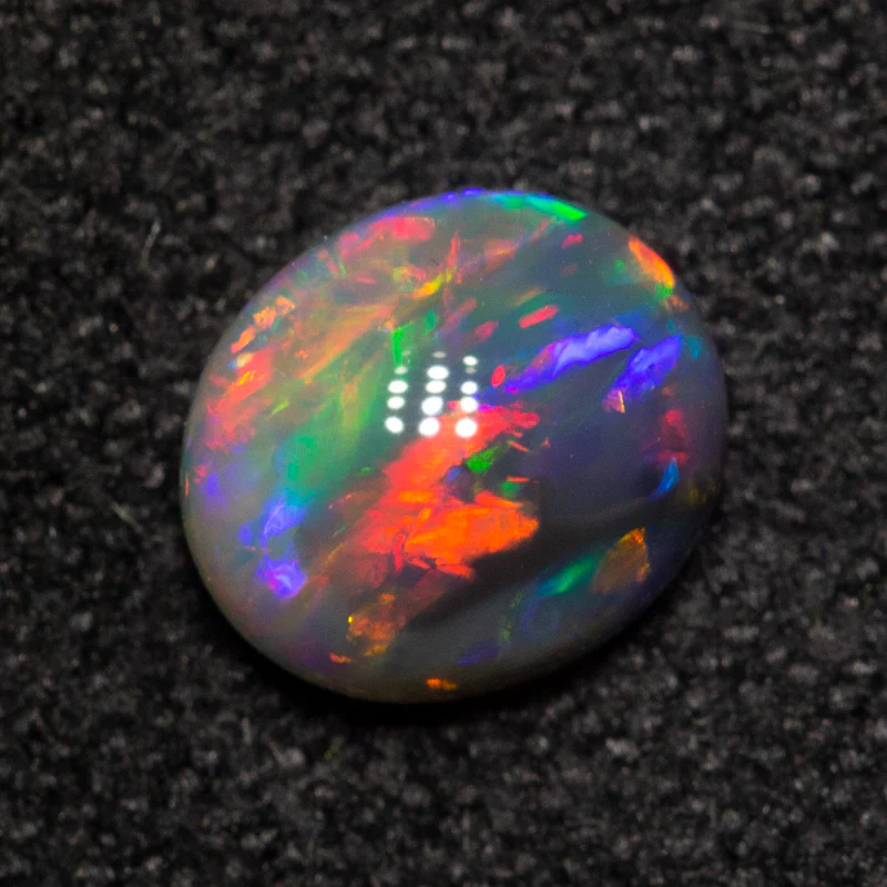 0.57 ct dark opal 6.1x5.3x2.8mm