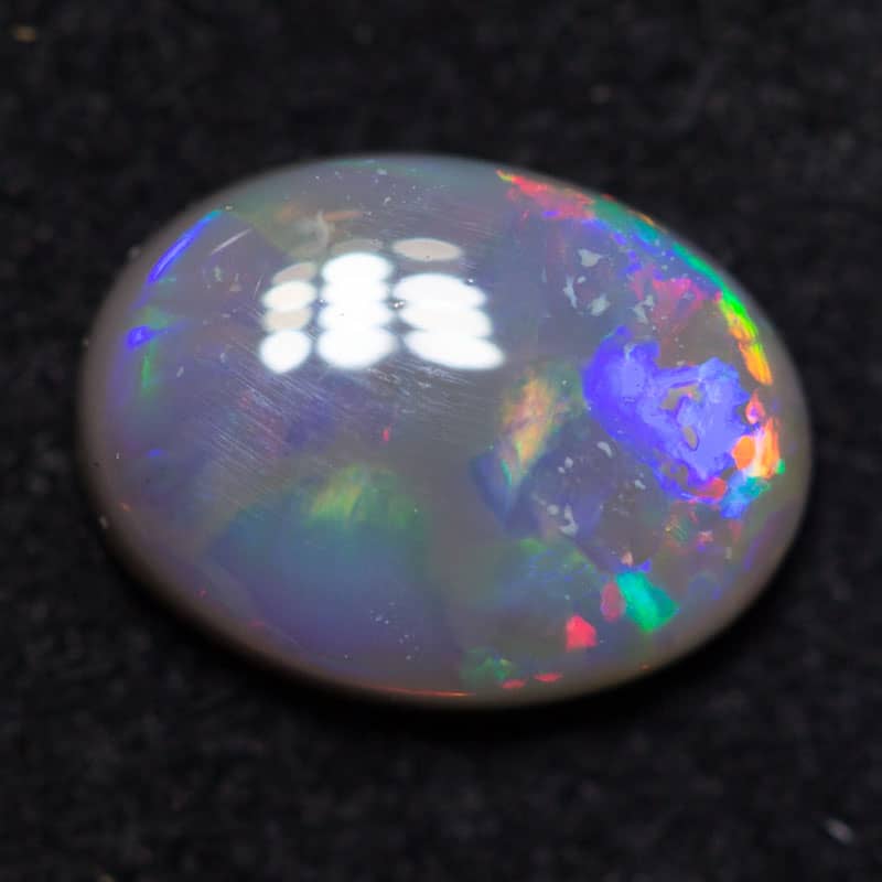 0.60 ct dark opal 7x5x2mm