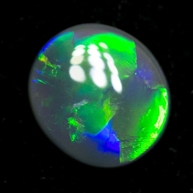 0.60 ct dark opal 7x6x2mm