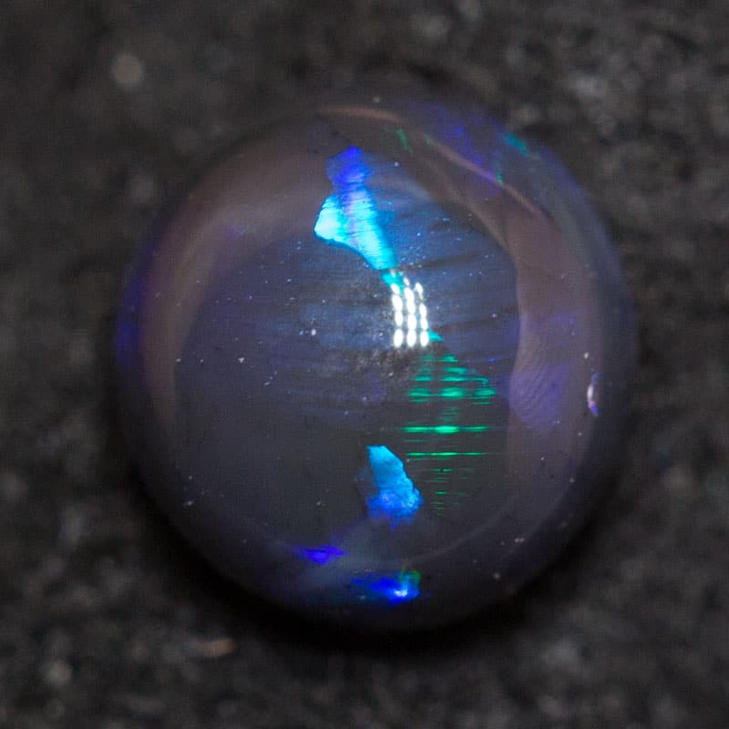 0.61 ct black opal 5.5x5.2x3.4mm