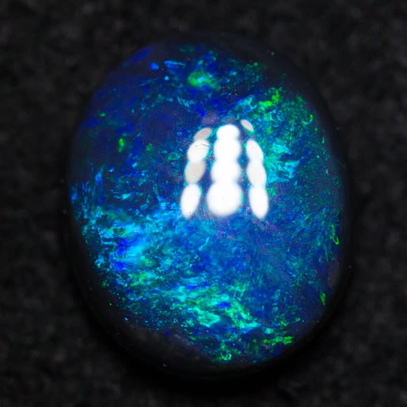 0.62 ct black opal 6.7x5.6x2.6mm