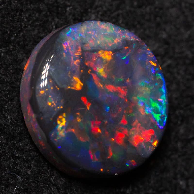 0.63 ct black opal 6.4x5.8x2.4mm