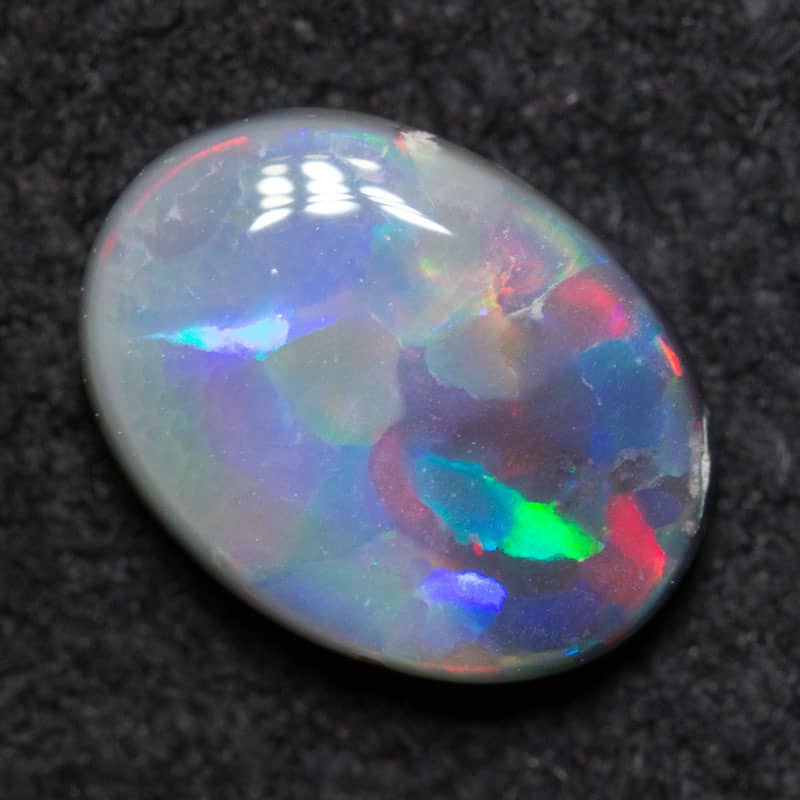 0.67 ct dark opal 7.6x5.7x2.3mm