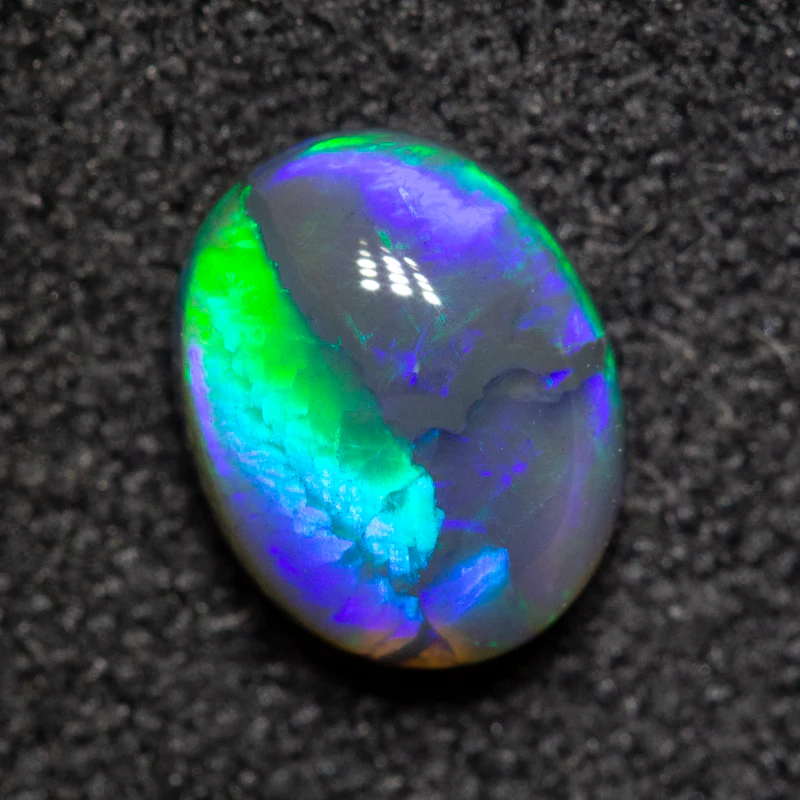 0.75 ct black opal 6.8x5.5x3.3mm