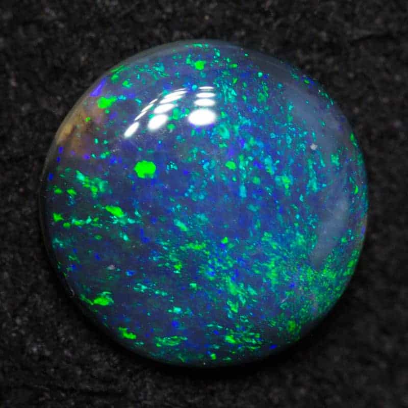 0.75 ct black opal 7.1mm round x 2.3mm