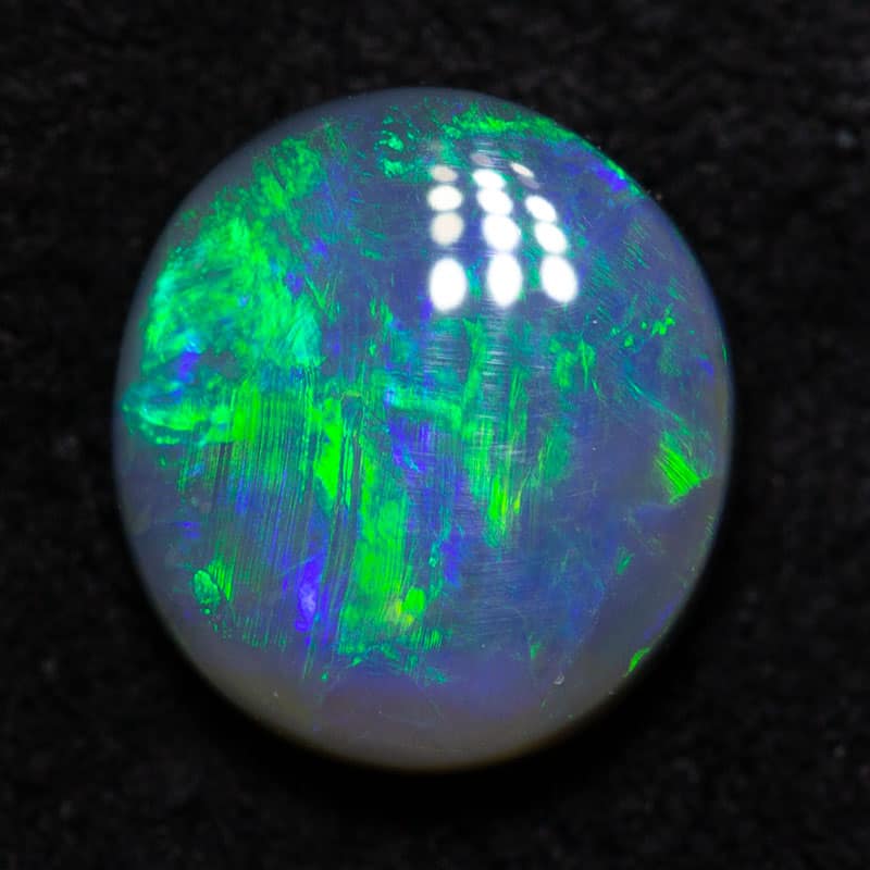 0.79 ct black opal 6.9x6.4x2.9mm