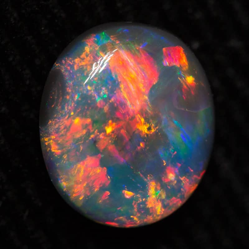 0.80 ct black opal gem 7.4x6.3x2.8mm