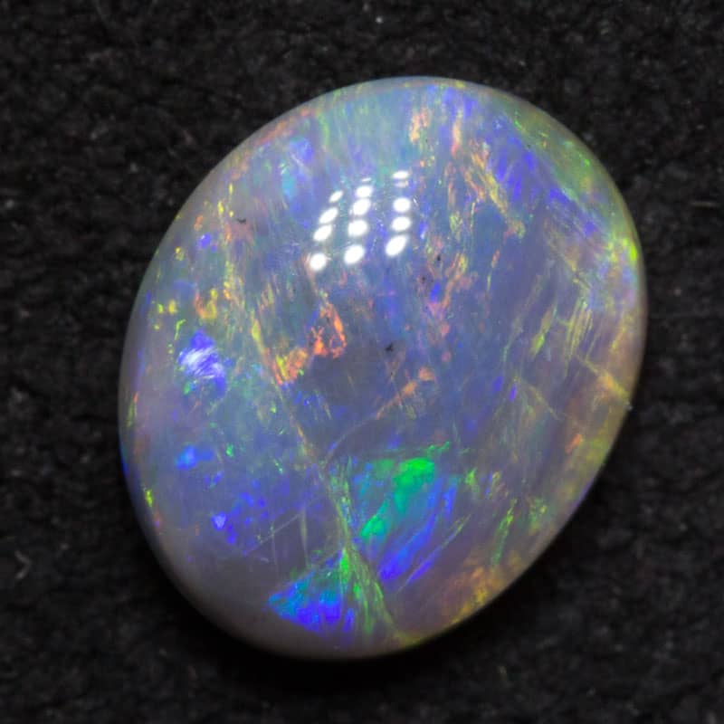 0.83 ct dark opal 7x6x3mm