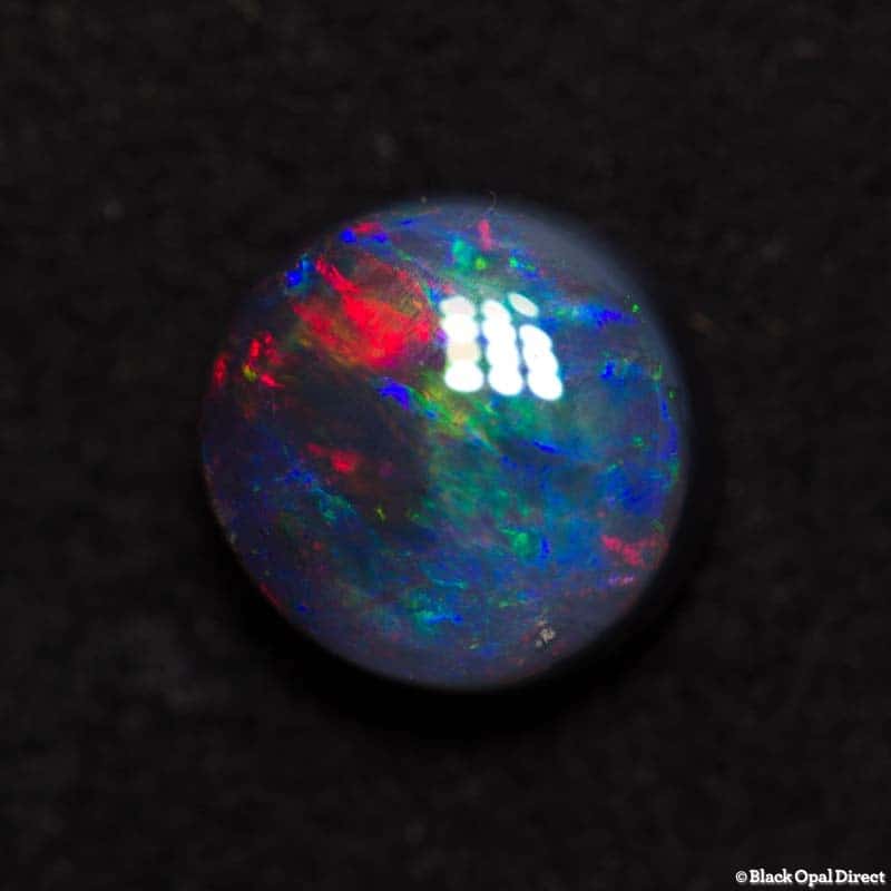 0.85 ct black opal 6mm round x3mm thick