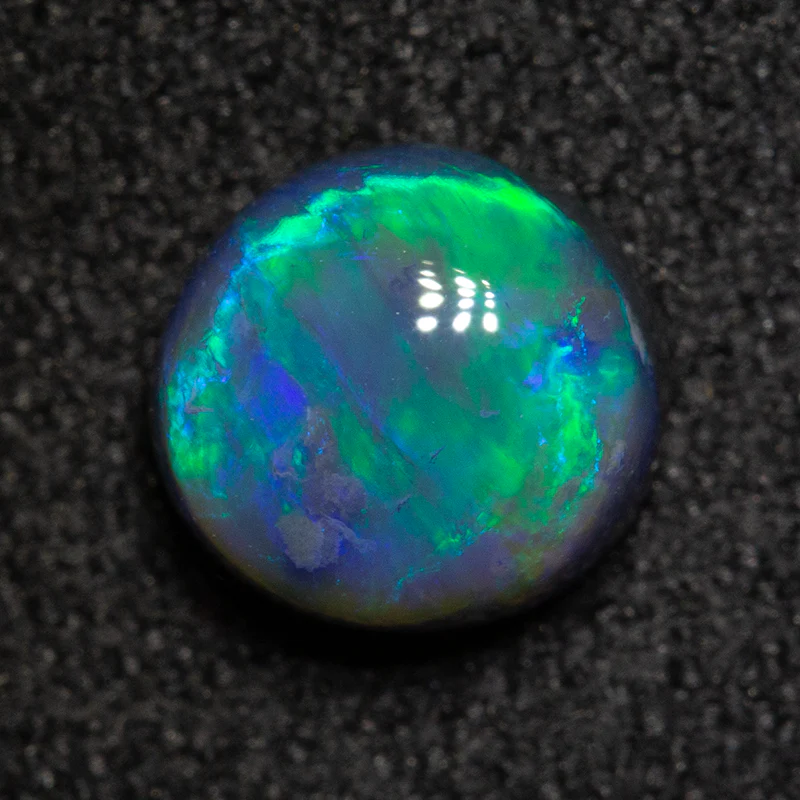 1.08 ct black opal 6.6x6.3x3.9mm