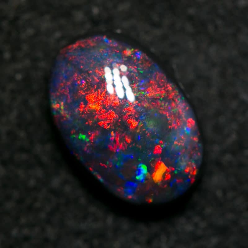 1.13 pigeon blood red black opal 8x5.5x3.5mm