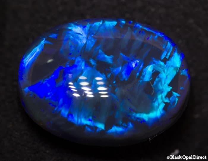 5.85 ct blue opal with chinese writing 14x10.5x6mm