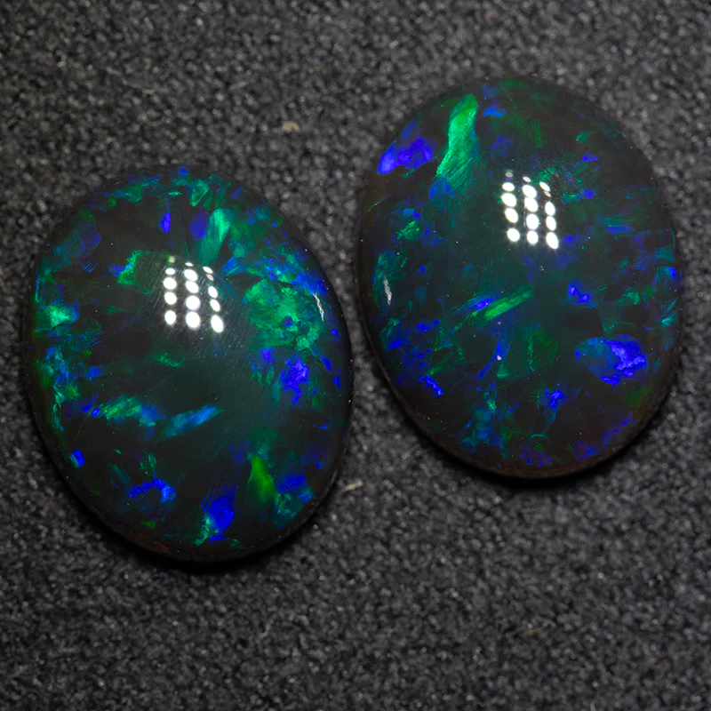 6.27 ct black opal pair 11.7x9.5x4.4mm